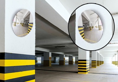 Safety mirrors installed in a warehouse aisle for blind spot visibility