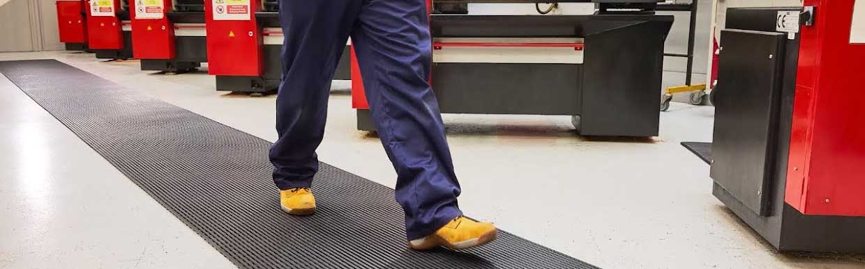 Workplace environment with anti-slip mats enhancing floor safety